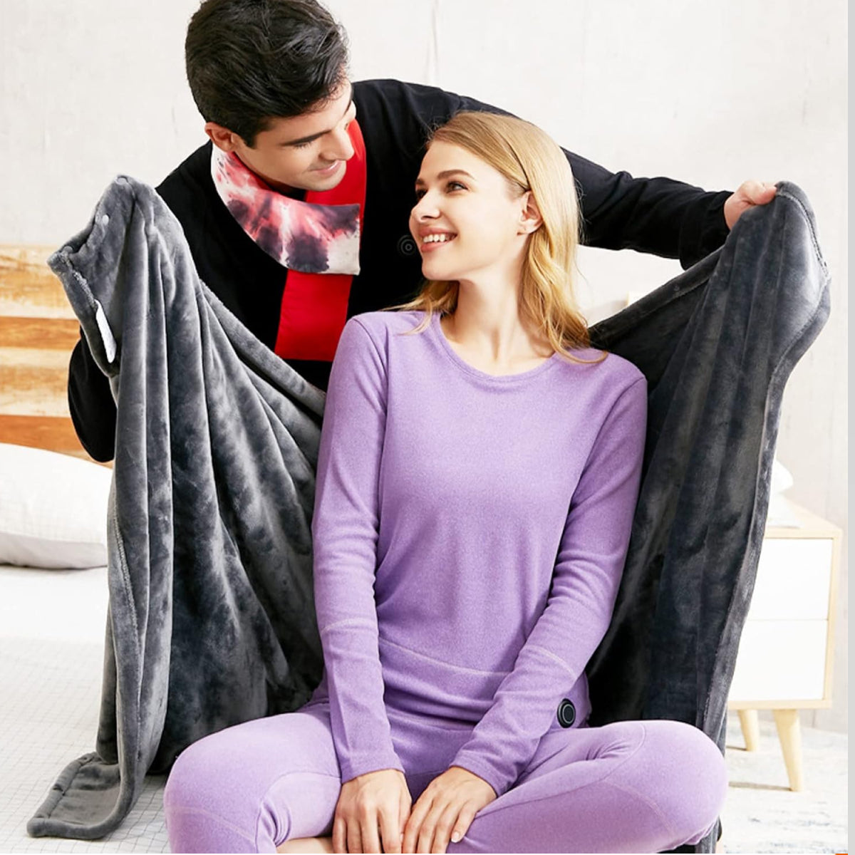 Portable heated shawl for warmth and comfort, ideal for the office, home or outdoor use. Rechargeable and cordless for convenience.